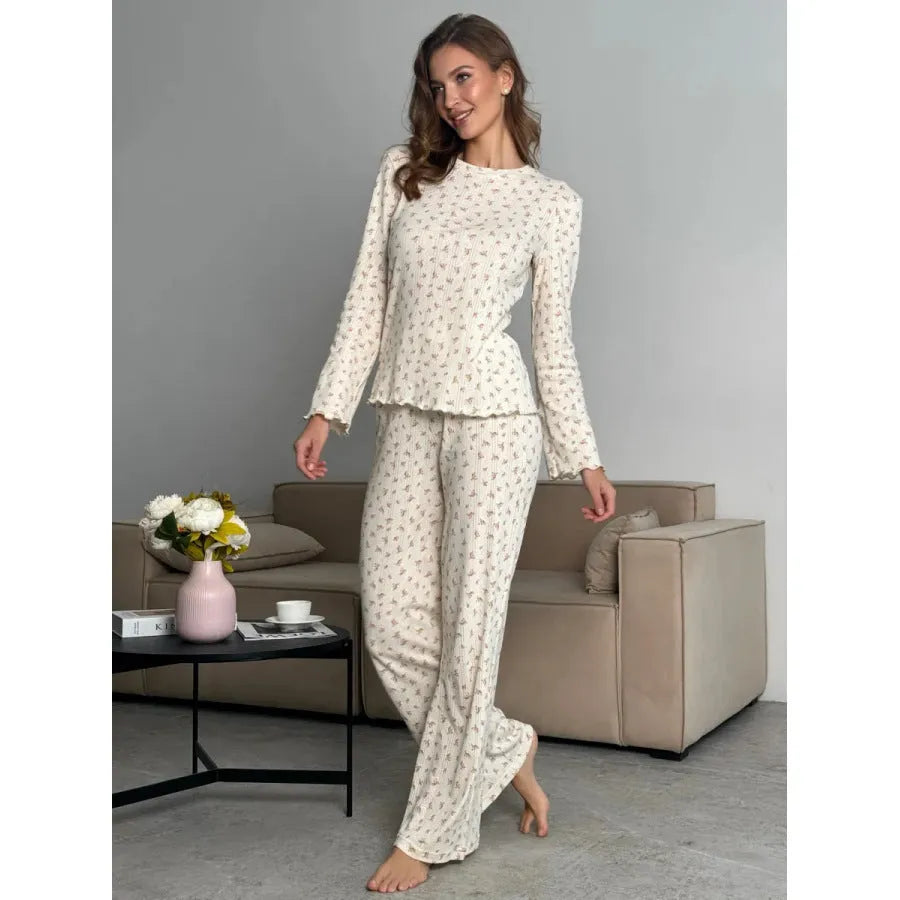 White women's floral print polyester two-piece suit with bell sleeve top and wide-leg trousers.