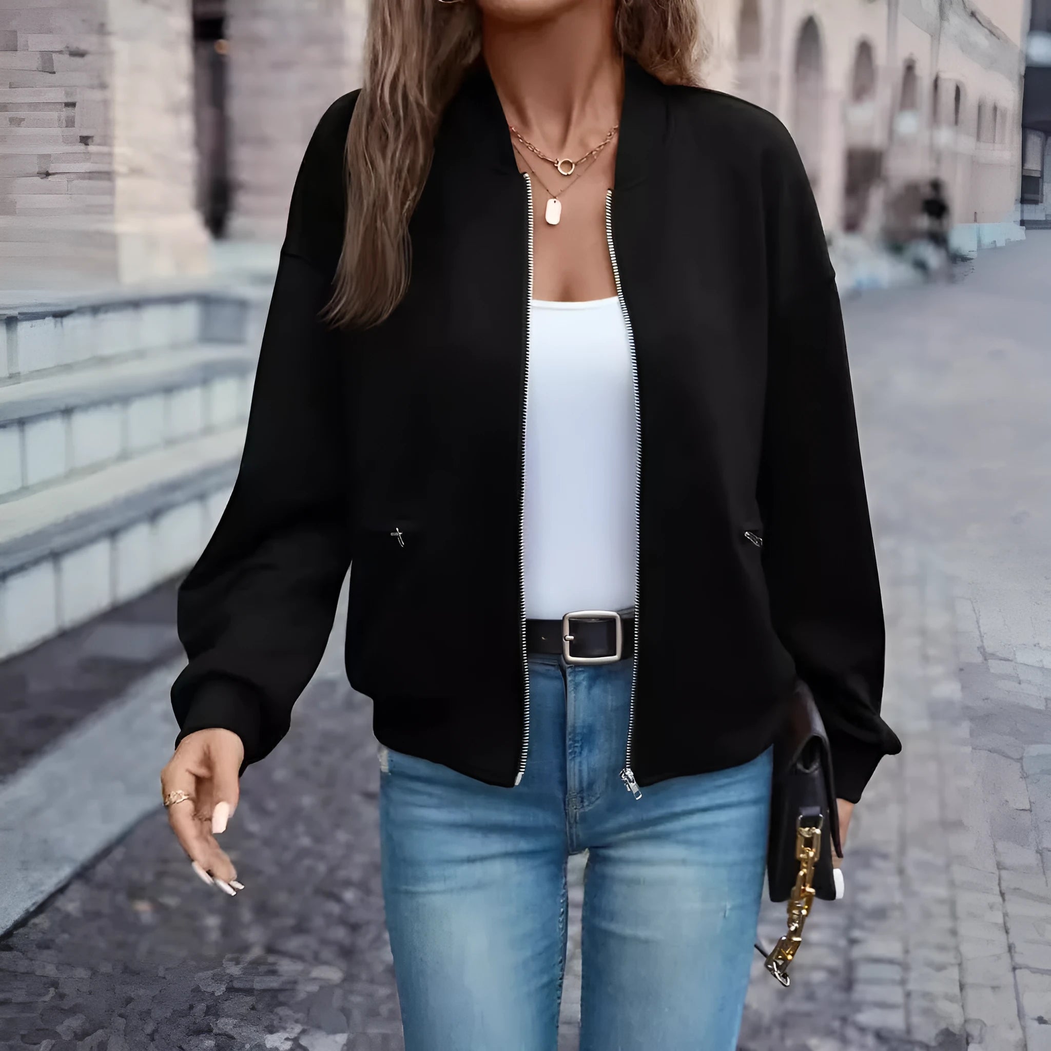 Black women's zip-front casual jacket with long sleeves on a hanger.