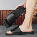 Brown and black men's outdoor leather sandals with rubber soles on a neutral background.