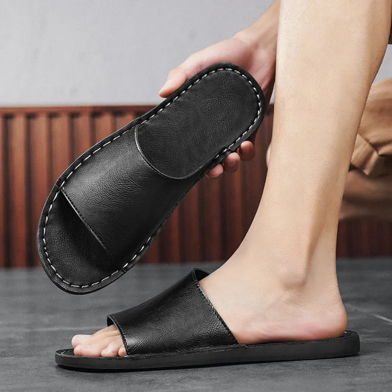 Brown and black men's outdoor leather sandals with rubber soles on a neutral background.