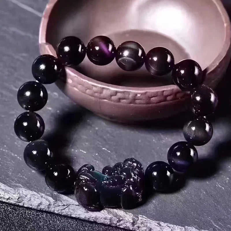 Natural ice colour eye obsidian crystal bracelet showing polished beads with characteristic banding patterns