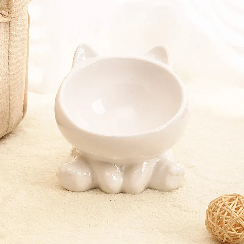 Ceramic cat bowl in black and white with oblique mouth shape on a light background