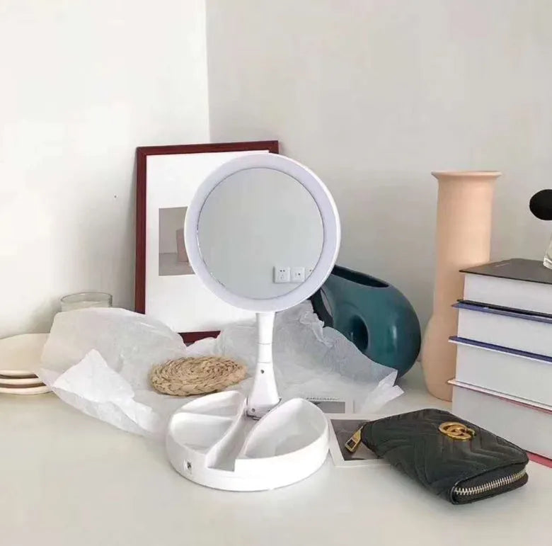 White acrylic frame double-sided LED vanity mirror folded with storage shelf visible