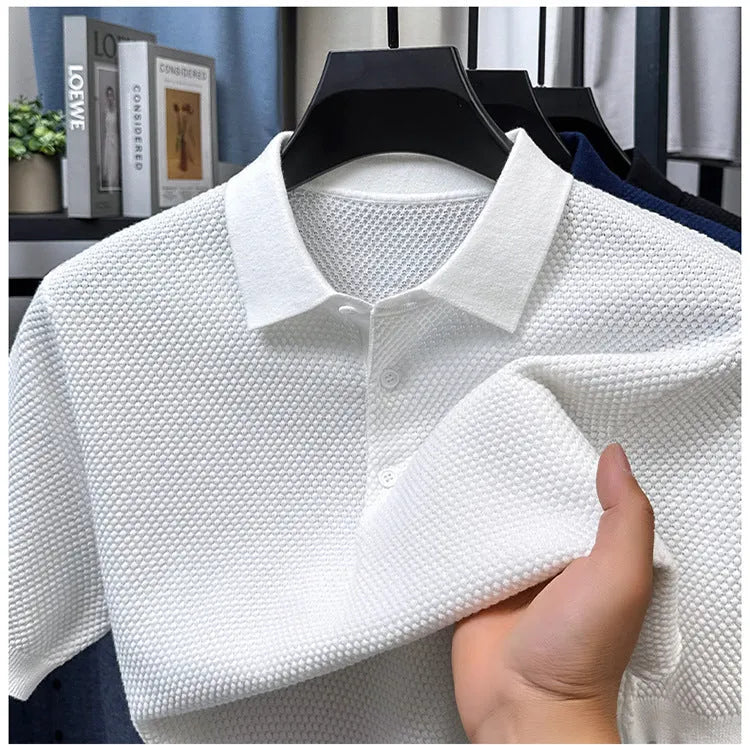 Man wearing a loose-fit grey short sleeve cotton pullover sweater for casual leisure wear.