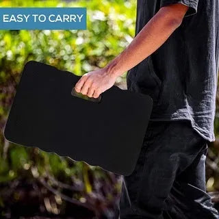 Solid blue EVA foam garden kneeler pad on soil for comfortable planting and weeding.