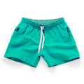 Men's plus-size polyester beach shorts in multiple colours on a size chart background.