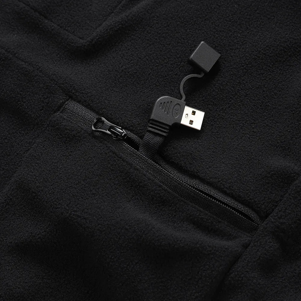 Children's black polar fleece heating jacket with zipper closure on a child