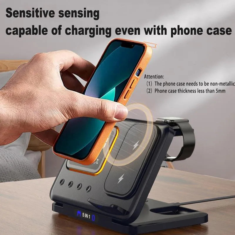 Black and white 5-in-1 wireless charging dock station with phone, watch and earphones charging, showing LED clock display.