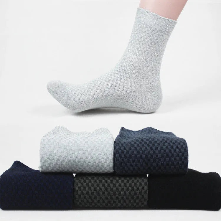 Men's bamboo fibre business socks in small square pattern, shown in classic colours on a grey background.