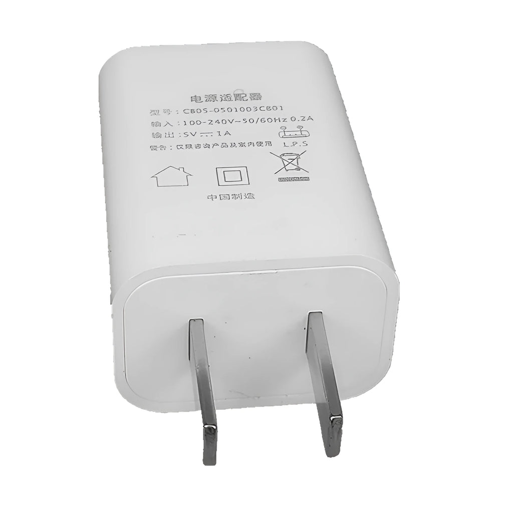 Slim white 5V 1A USB wall charger with CE and FCC marks on label.