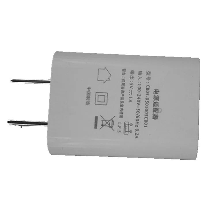 Slim white 5V 1A USB wall charger with CE and FCC marks on label.