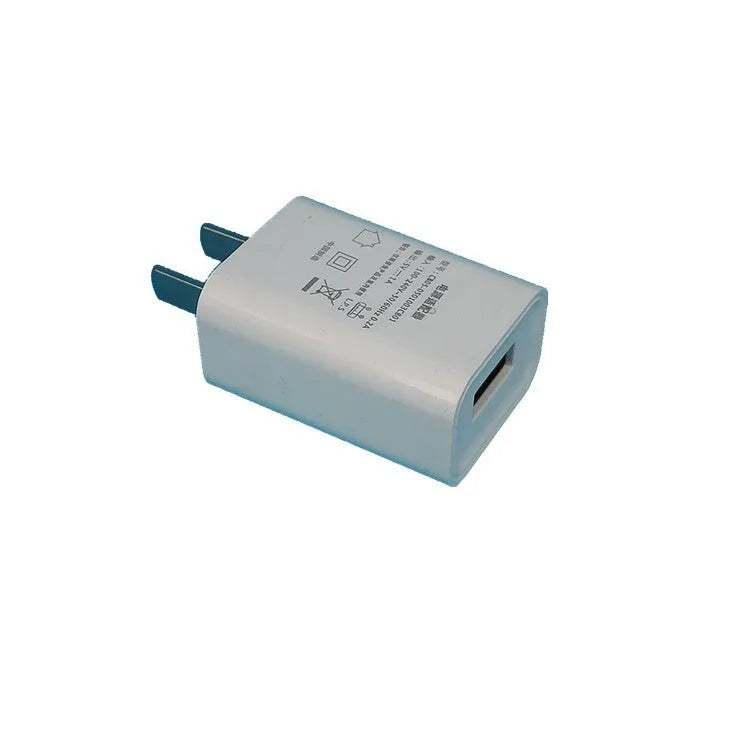 Slim white 5V 1A USB wall charger with CE and FCC marks on label.