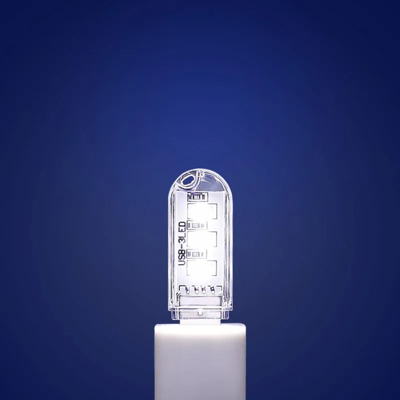 Small white LED night light with USB cable showing compact 6cm bedside design