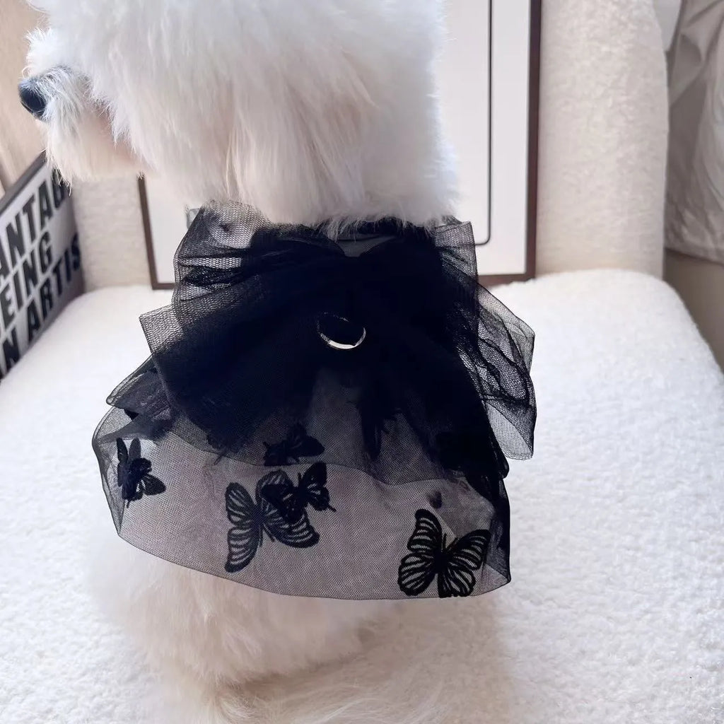Black polyester tulle princess skirt for a small dog or cat on a hanger.