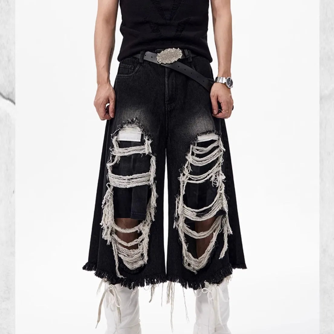 Women's black cropped wide leg jeans with ripped patch details and mid-high waist