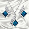 Women's electroplated necklace and earring set with cross chain design and glass pendant