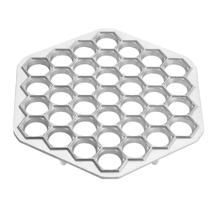 Aluminum alloy 37 hole dumpling mold for pressing multiple dumplings simultaneously on a kitchen counter