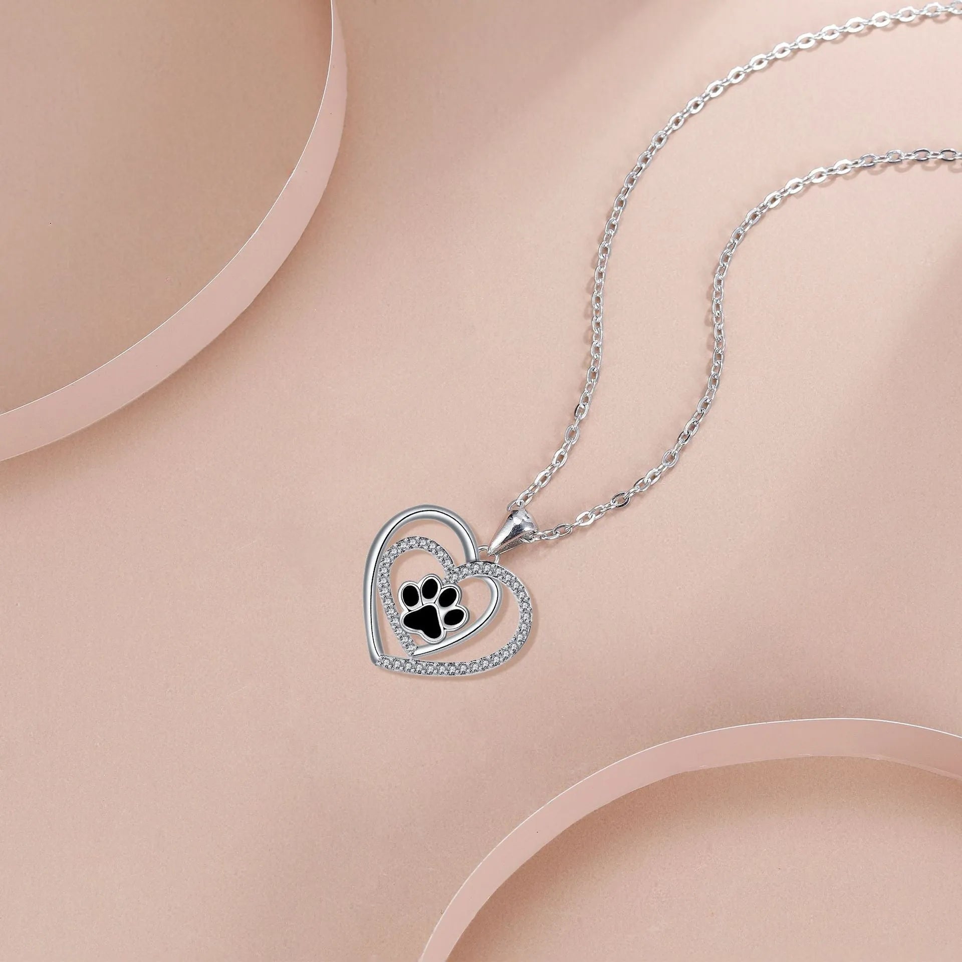 Women's copper heart-shaped pendant necklace with detailed dog's paw prints and cross chain