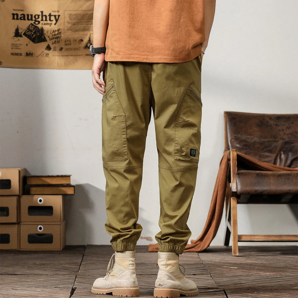 Men's cotton harem pants with ankle banded legs in khaki colour showing zip placket fly detail