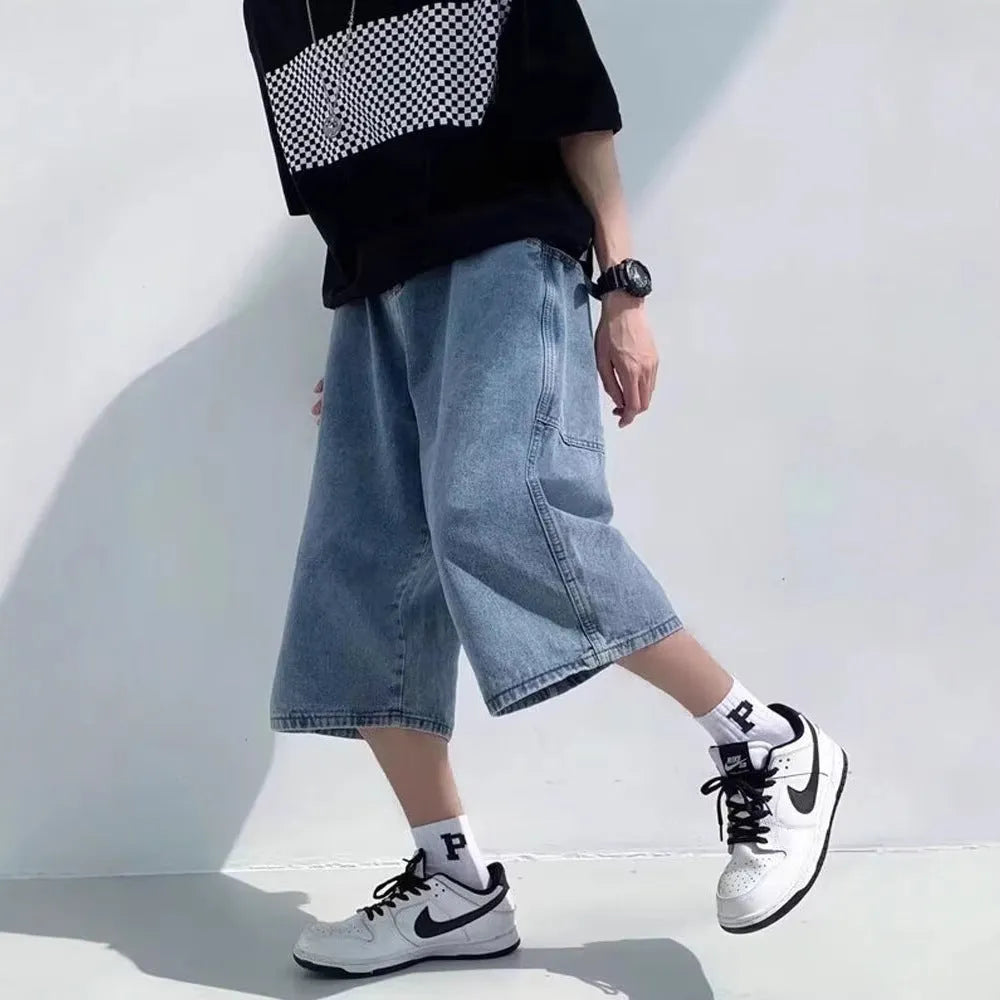 Men's washed light blue denim cropped shorts with a high waist and zipper fly.