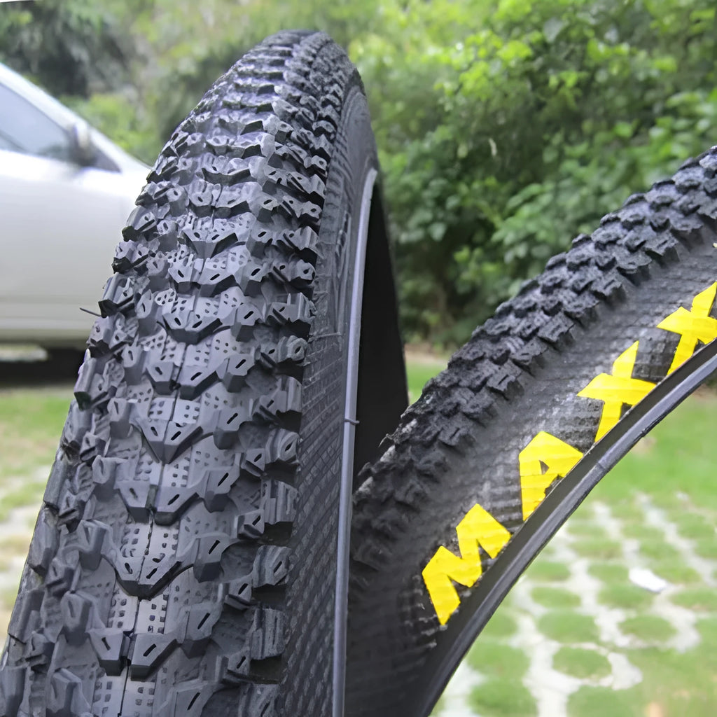 Ultralight puncture-proof mountain bike tyre shown in multiple sizes including 26, 27.5 and 29-inch options.