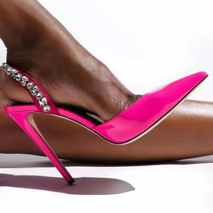 Women's pointed toe high heel sandals with rhinestone side detail on patent leather upper.