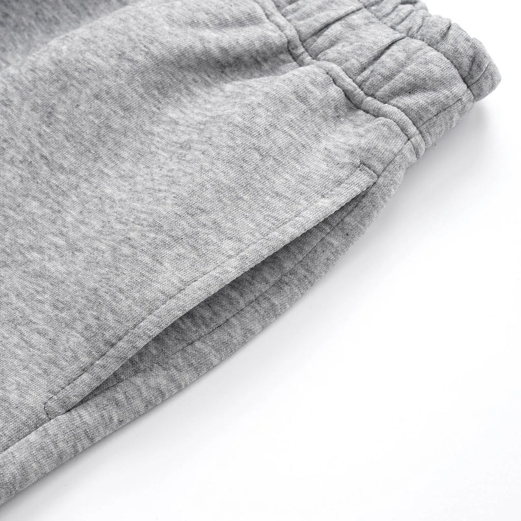 Men's grey cotton trousers with straight wide-leg fit on hanger