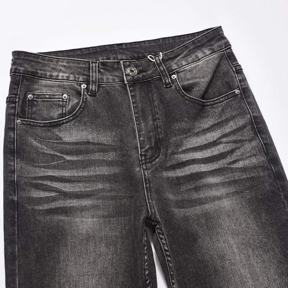 Men's black washed wear-white denim jeans on a plain background showing front view