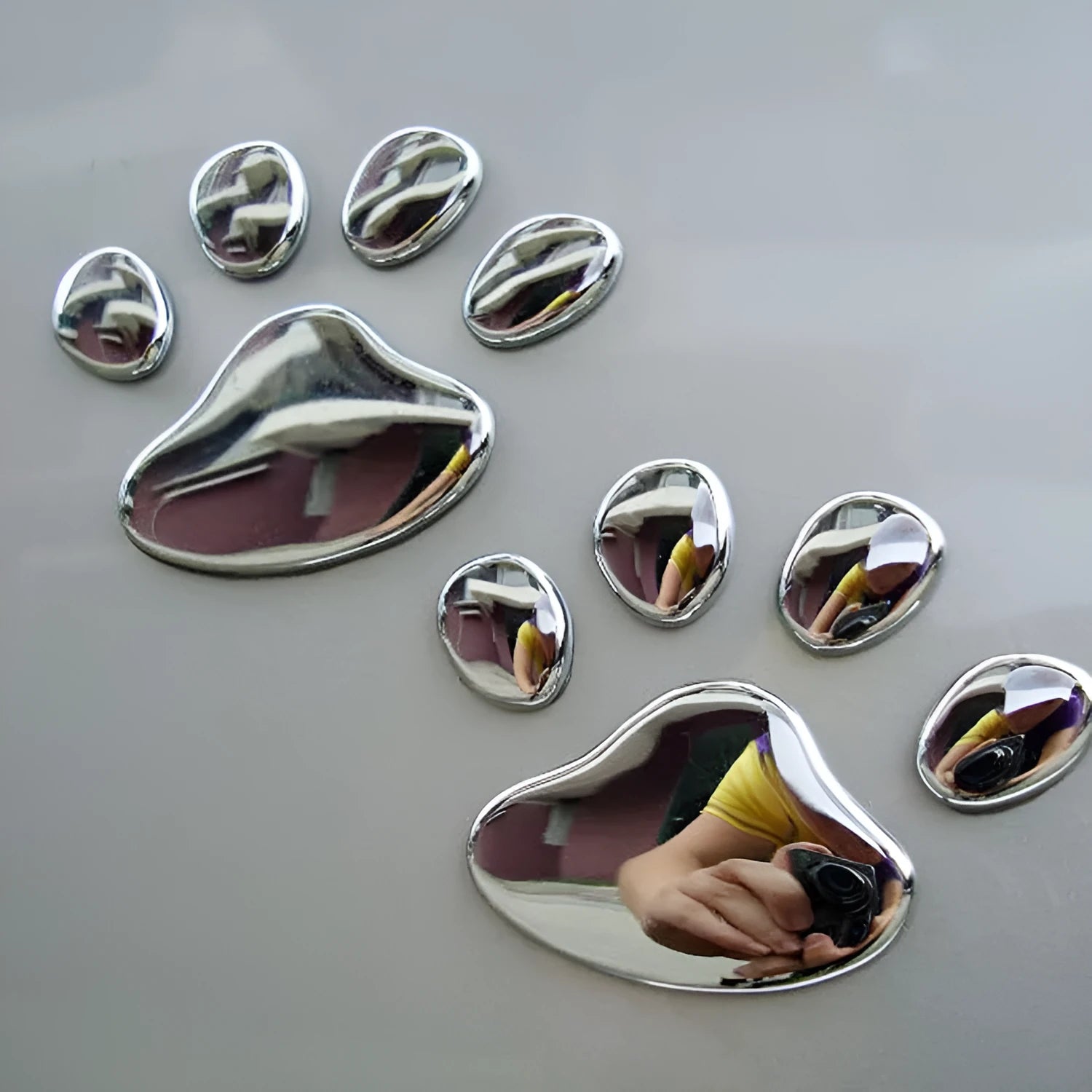 Hand-shaped brush design PVC car sticker with dog footprint pattern, shown in silver colour.