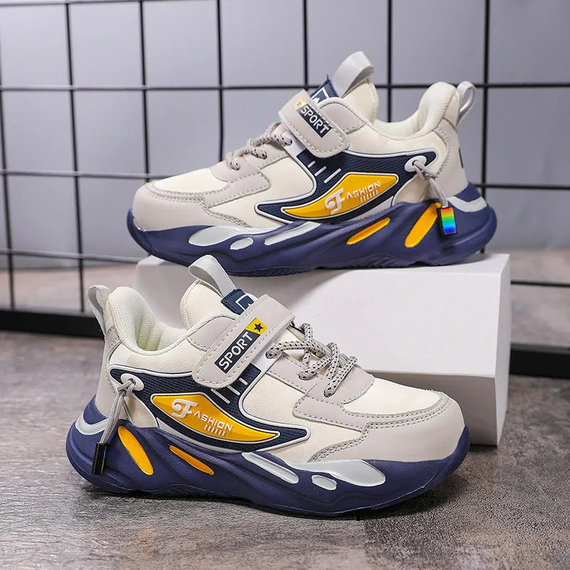 Boys' blue and black platform sports running shoes with Velcro strap on a hard ground surface.