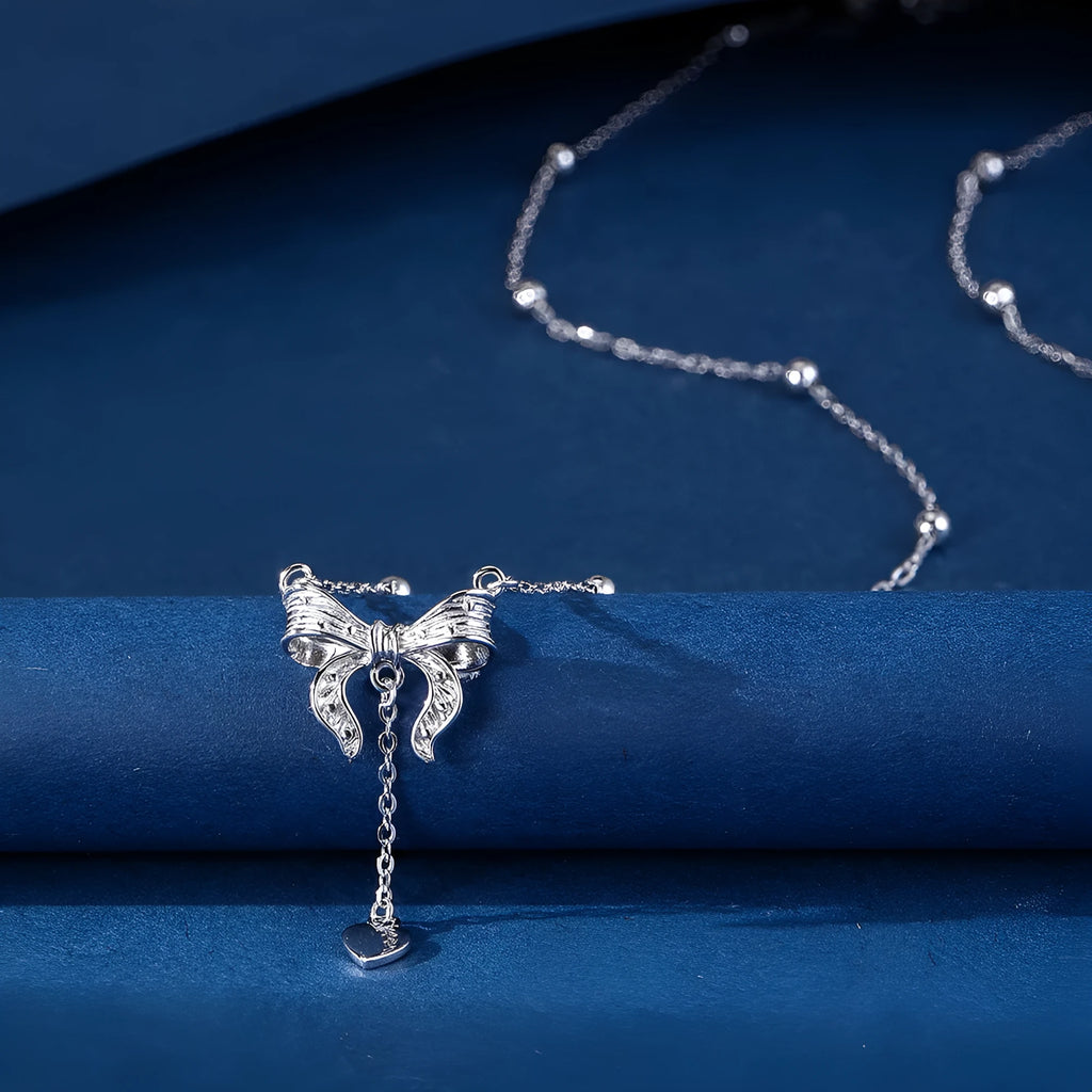 Silver butterfly heart pendant necklace with bow detail on O-ring chain