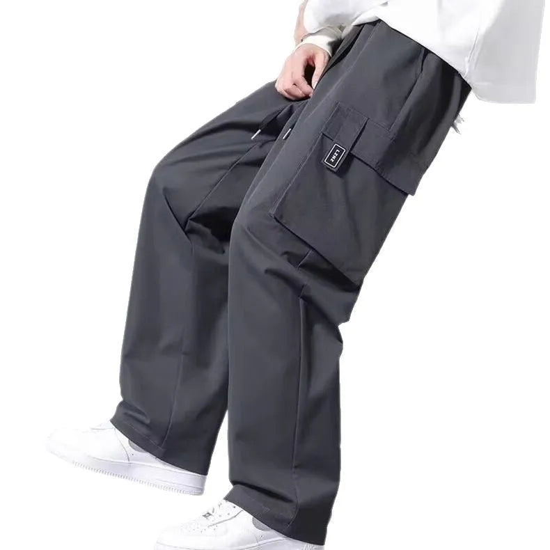 Boy's straight-leg cargo trousers in Army Green with drawstring waist and large side pockets.