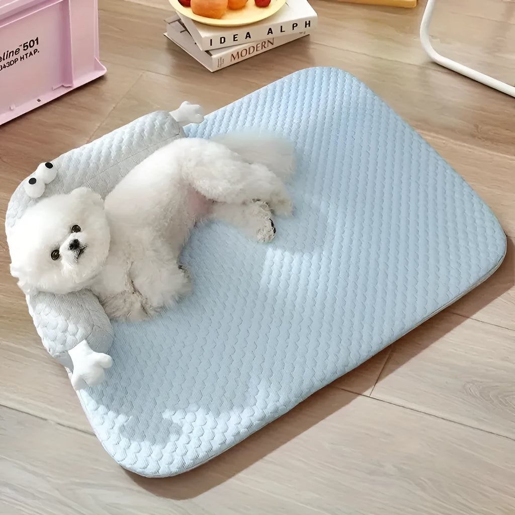 Blue and yellow big-eyed monster design pet bed cushion for dogs and cats on a wooden floor.
