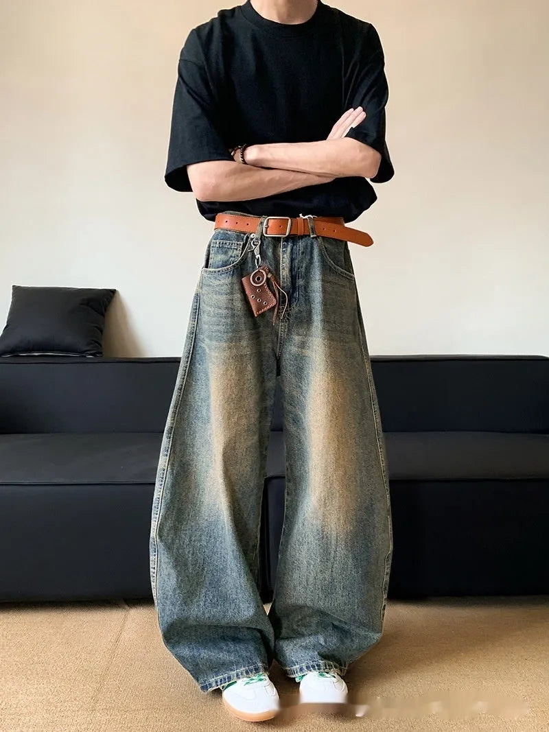 Men's retro blue distressed denim jeans with a wide-leg slim fit and micro elasticity.