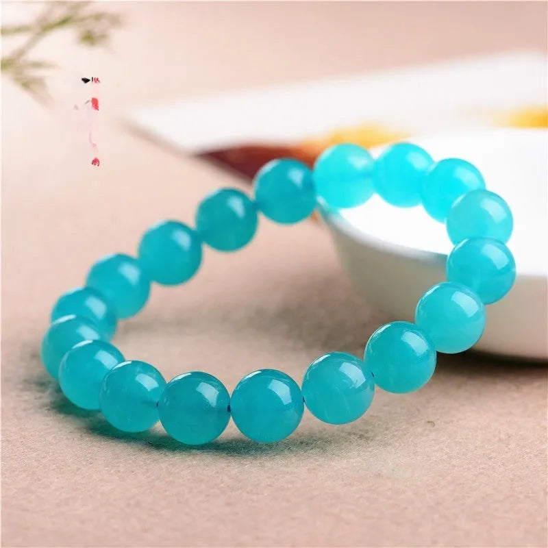 Grade 7A Amazonite natural scattered beads in ice blue and green, showing polished round and three-ring bead styles for bracelet making.