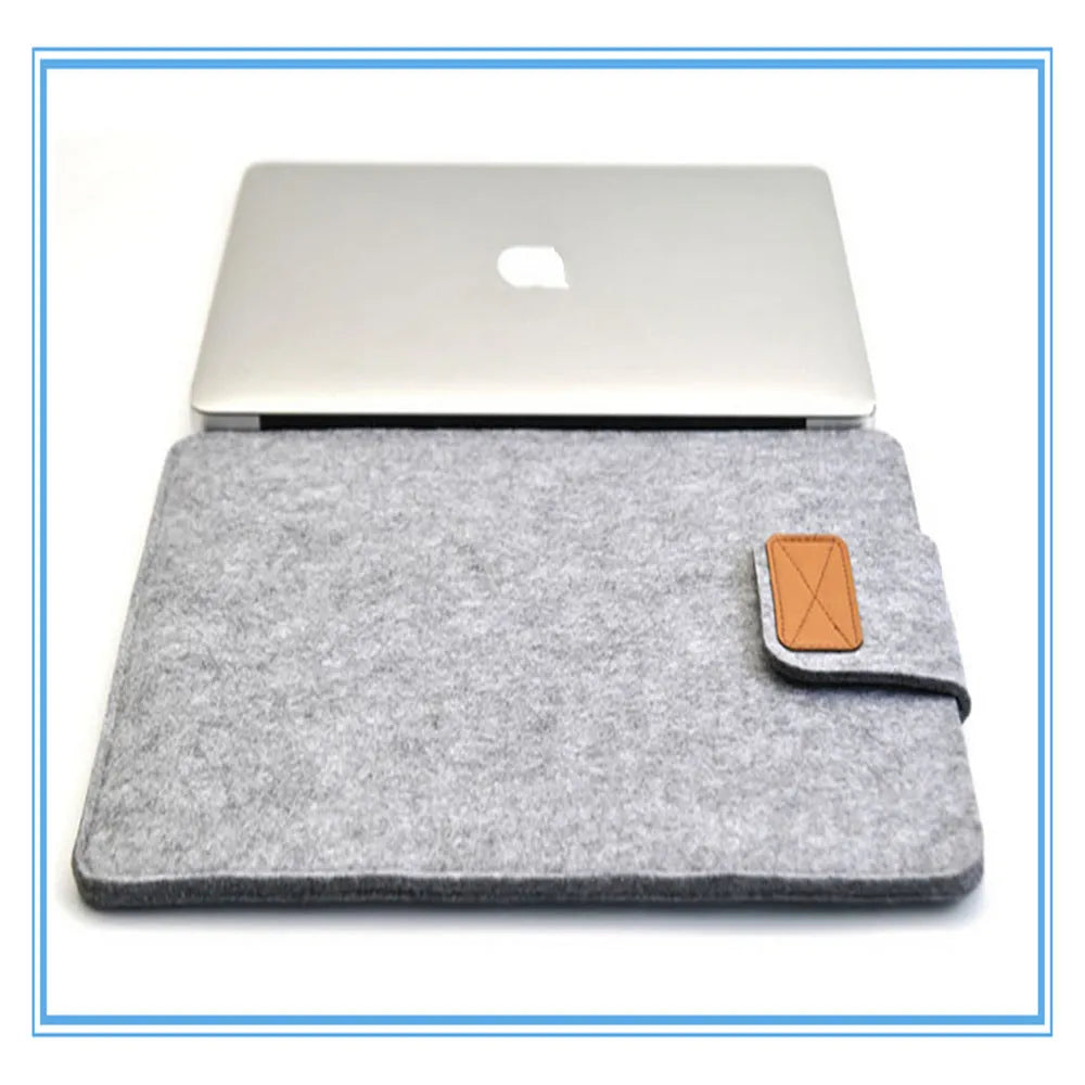 Clamshell laptop bag in dark grey with woven texture, shown open to reveal plush interior lining.