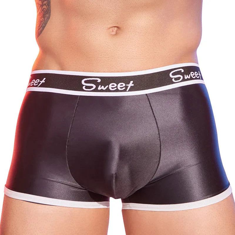 Men's silky nylon boxers in black, white, and sapphire blue colours on a plain background