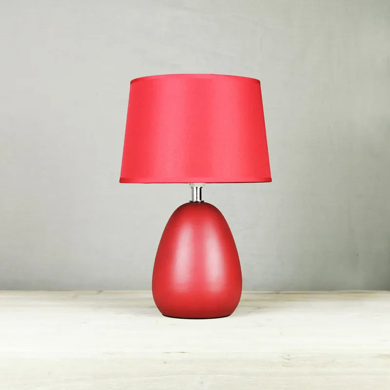 Small Nordic minimalist ceramic desk lamp in pink with LED light on desk