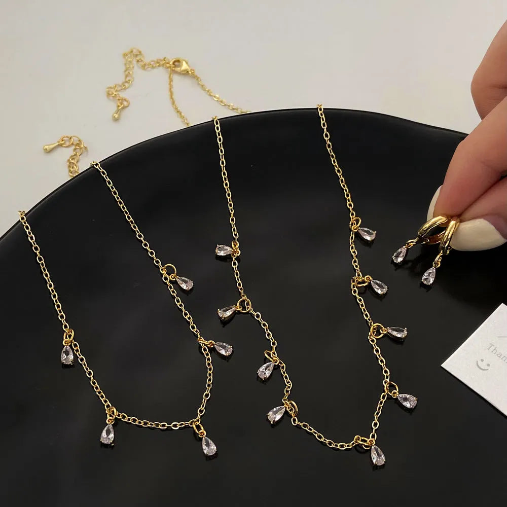 Women's three-piece zircon jewellery set showing necklace, anklet and earrings with geometric meteor shower design