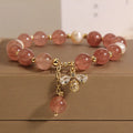 Freshwater pearl and strawberry quartz bracelet with zircon accents on wrist