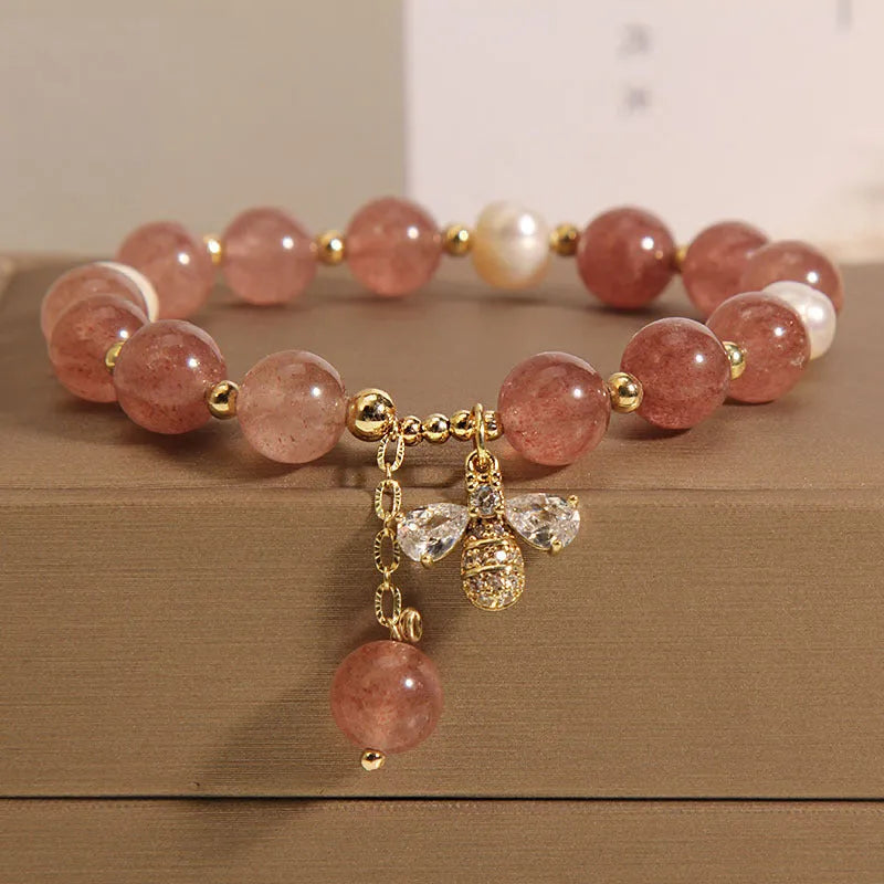 Freshwater pearl and strawberry quartz bracelet with zircon accents on wrist