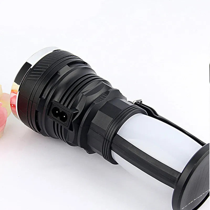 Black solar-powered and USB-rechargeable LED emergency flashlight with press switch.