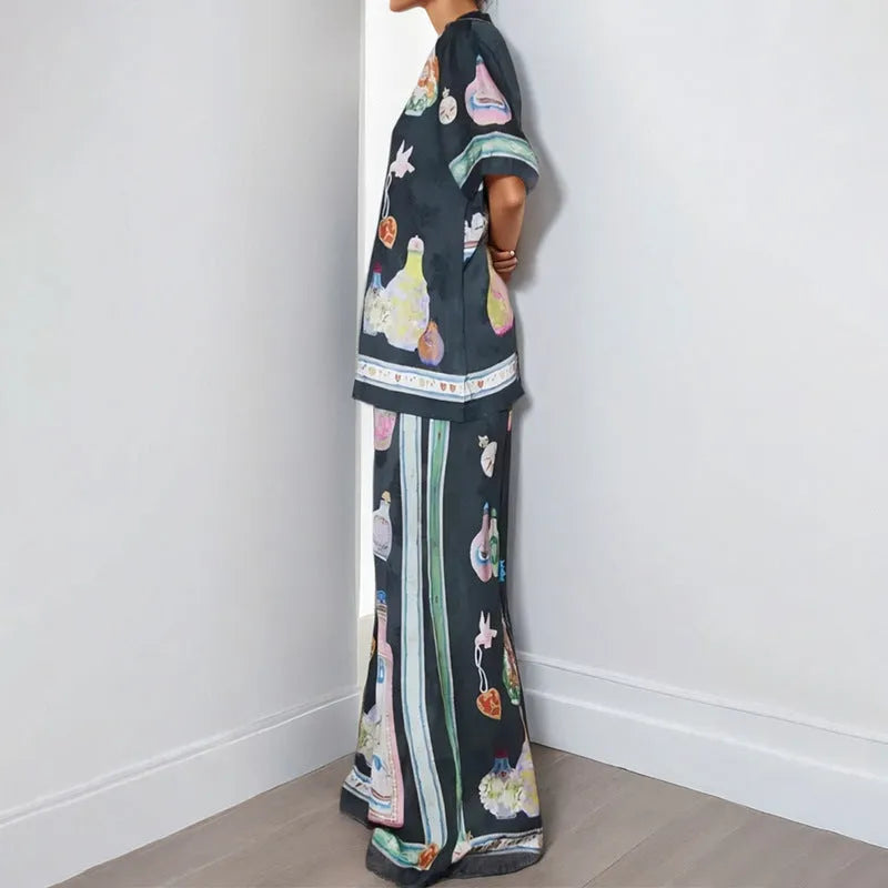 Black women's cardigan and pants set with cartoon animation print.