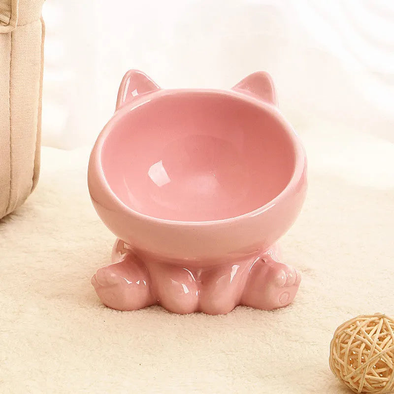 Ceramic cat bowl in black and white with oblique mouth shape on a light background