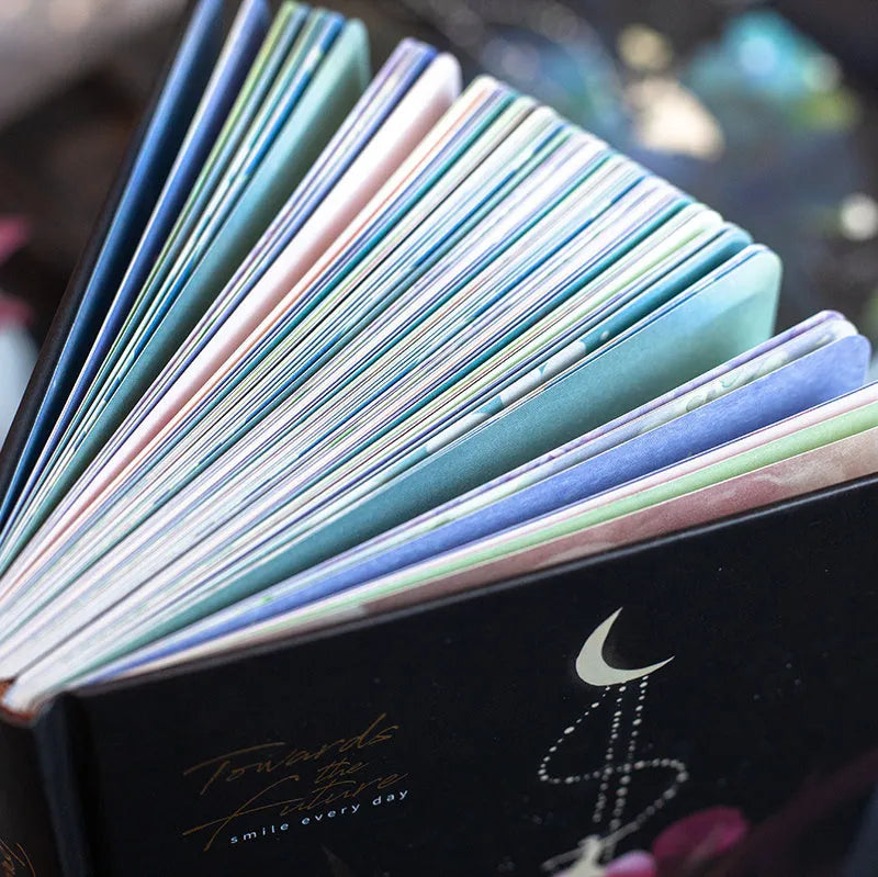 A5 notebook with luminous cover open to show pages filled with colour illustrations