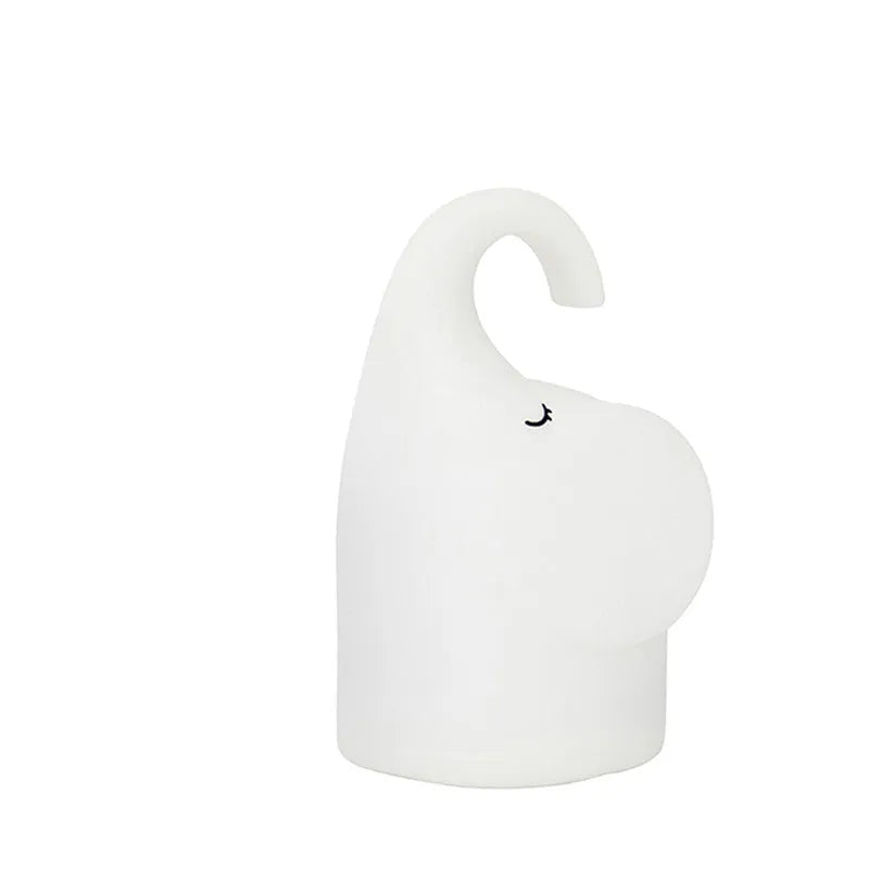 Elephant-shaped silicone night light with warm white LED illumination measuring 96mm wide by 151mm high