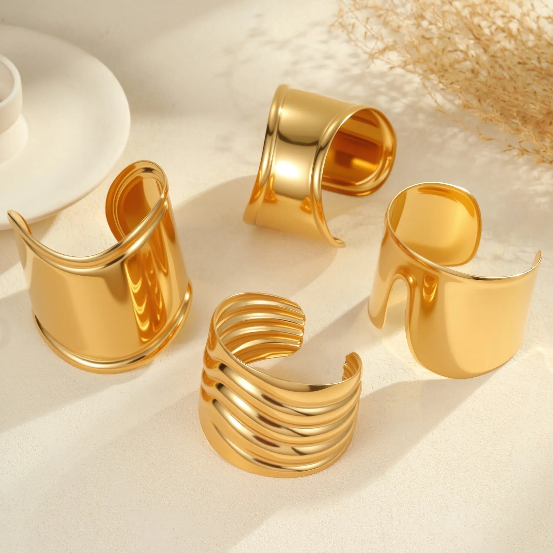 Women's wide stainless steel bracelet with gold plating and niche opening design