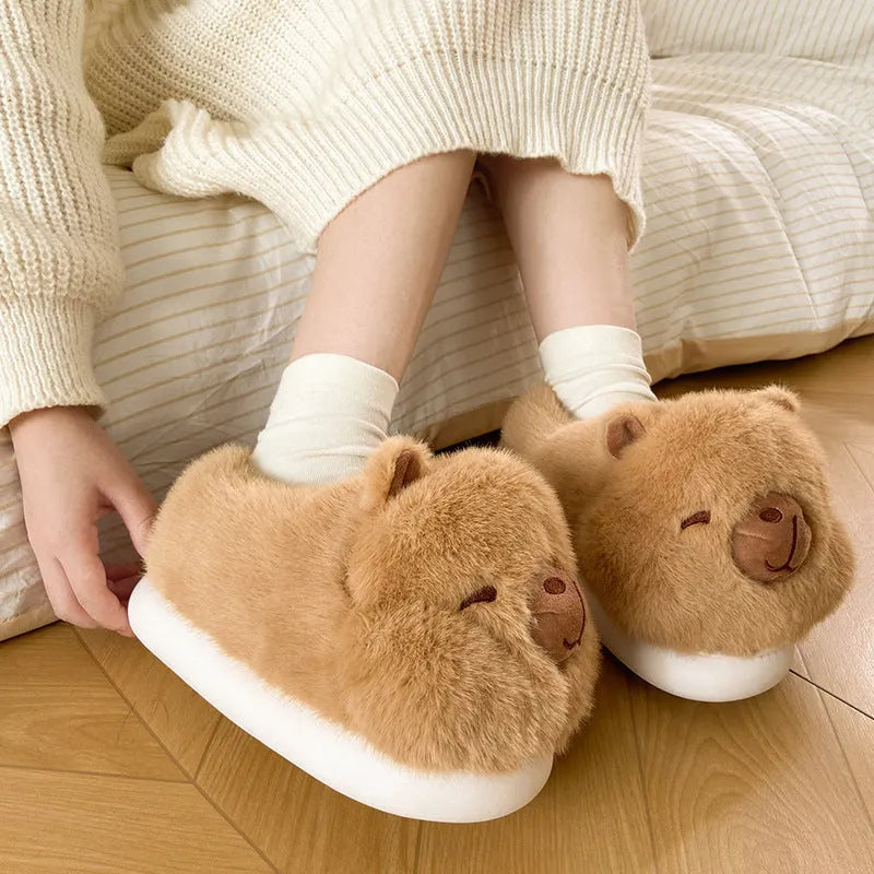Light brown women's winter slippers with cotton plush upper and cartoon pattern.