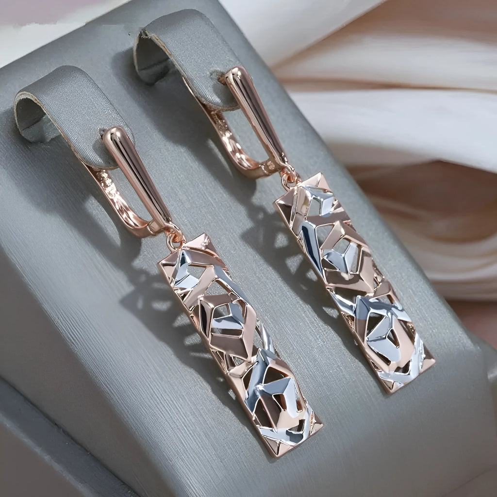 A pair of geometric hollow two-tone stud earrings with a rectangular shape and electroplated alloy finish.