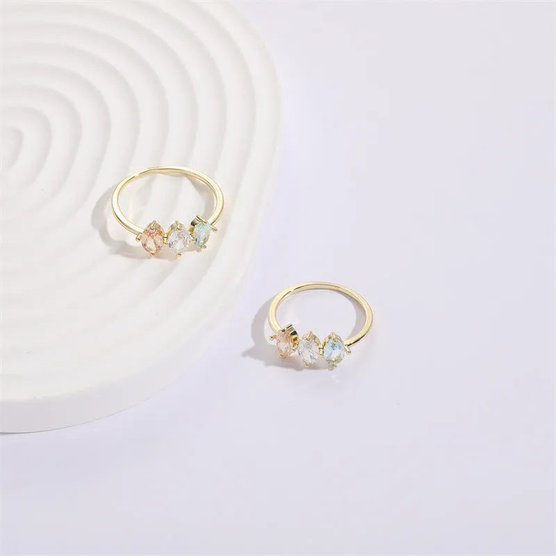 Geometric triangular copper women's ring with tricolour zircon stones and electroplated gold colour finish